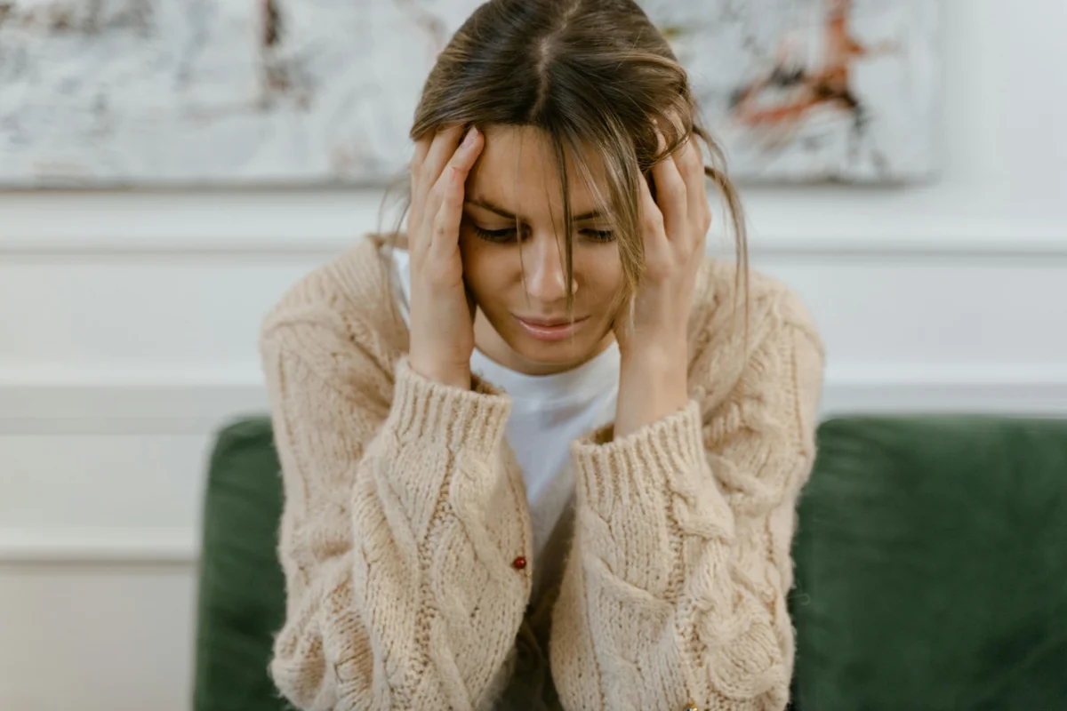 Woman experiencing migraine symptoms while seeking alternative treatment options in Colorado Springs