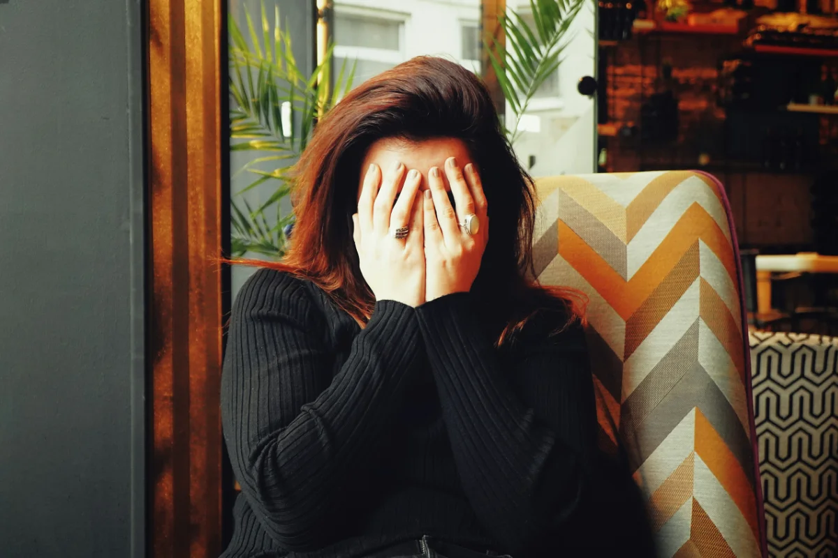 Woman experiencing migraine symptoms in Colorado Springs